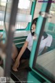 A woman sitting on a bus looking out the window.