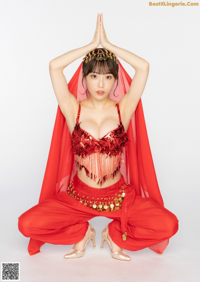 A woman in a red outfit is posing for a picture.